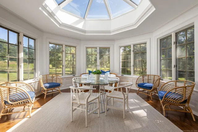 a living room with furniture and floor to ceiling windows