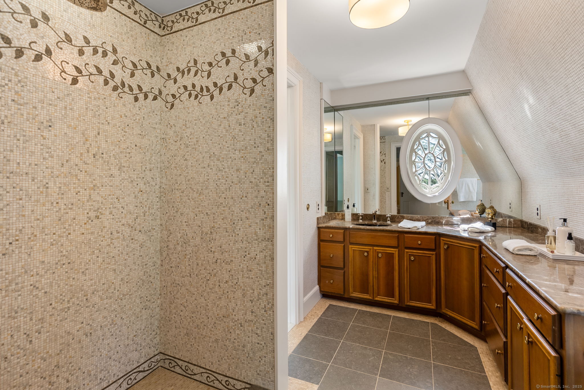 221 Greens Farms Road Westport, CT 06880 - Photo 23 of 39 a spacious bathroom with a granite countertop sink a mirror and vanity