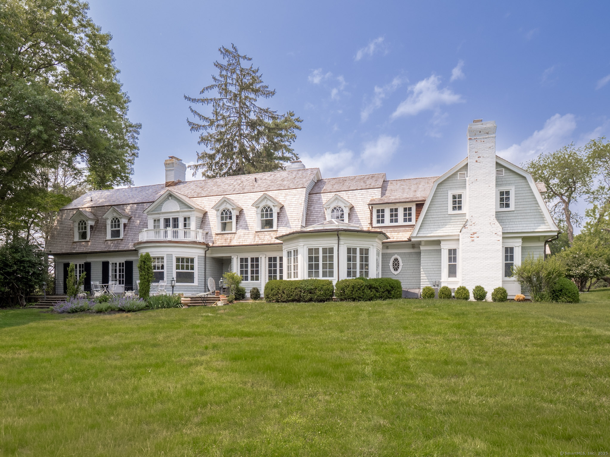 221 Greens Farms Road Westport, CT 06880 - Photo 32 of 39 a front view of a house with a garden