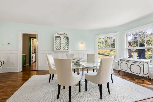 a view of a dining room with furniture and a window