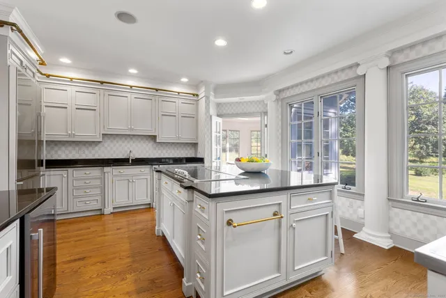 a kitchen with stainless steel appliances granite countertop a sink and cabinets