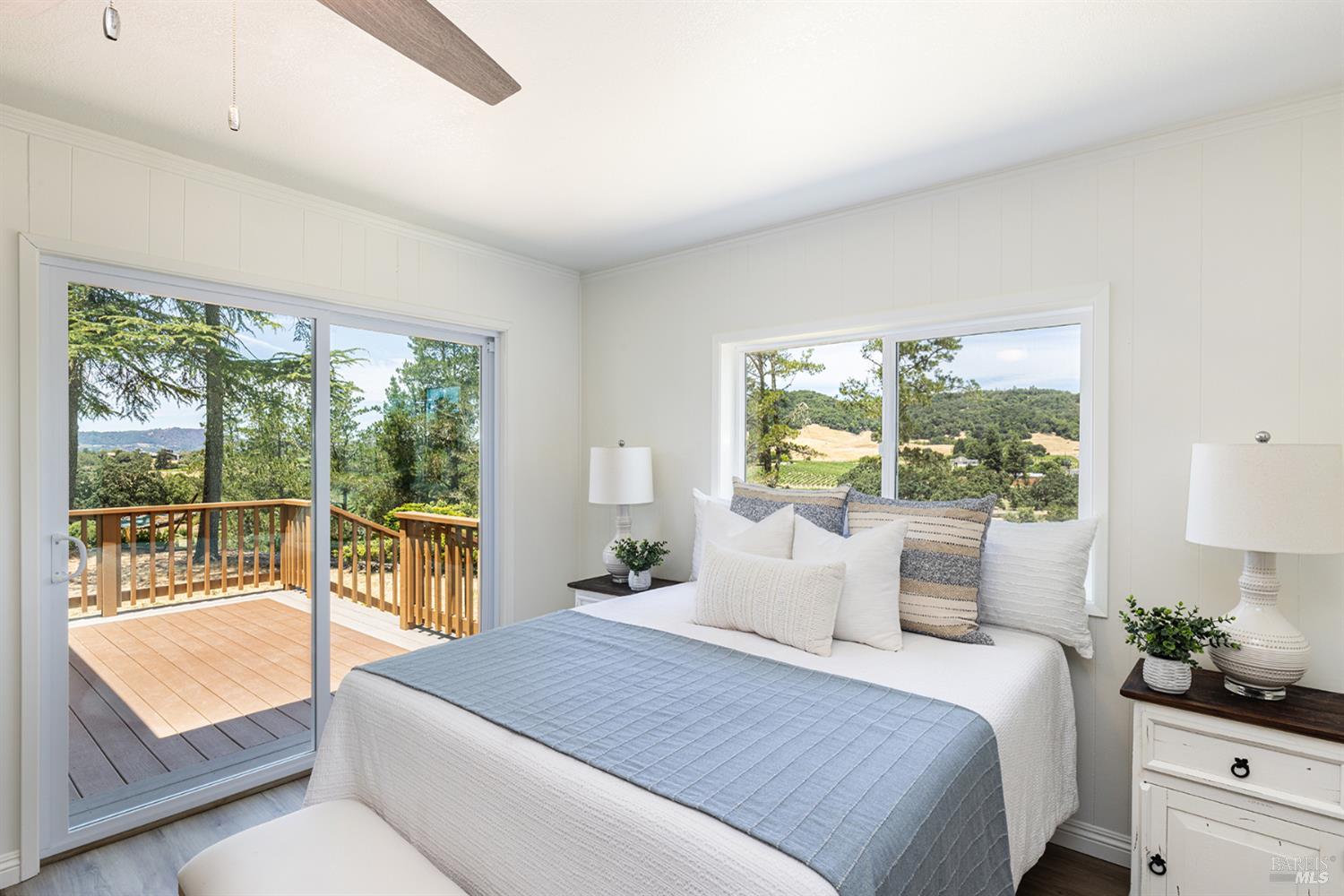 1676 Chiquita Road Healdsburg, CA 95448 - Photo 29 of 46 2nd bedroom ensuite with walk-in closet, and glass doors that lead to deck and the beautiful outdoor setting.