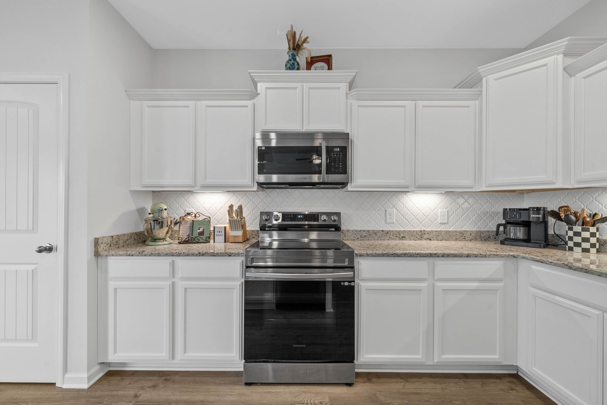 315 Windyhill Street Murfreesboro, TN 37129 - Photo 12 of 38 a kitchen with granite countertop white cabinets and stainless steel appliances