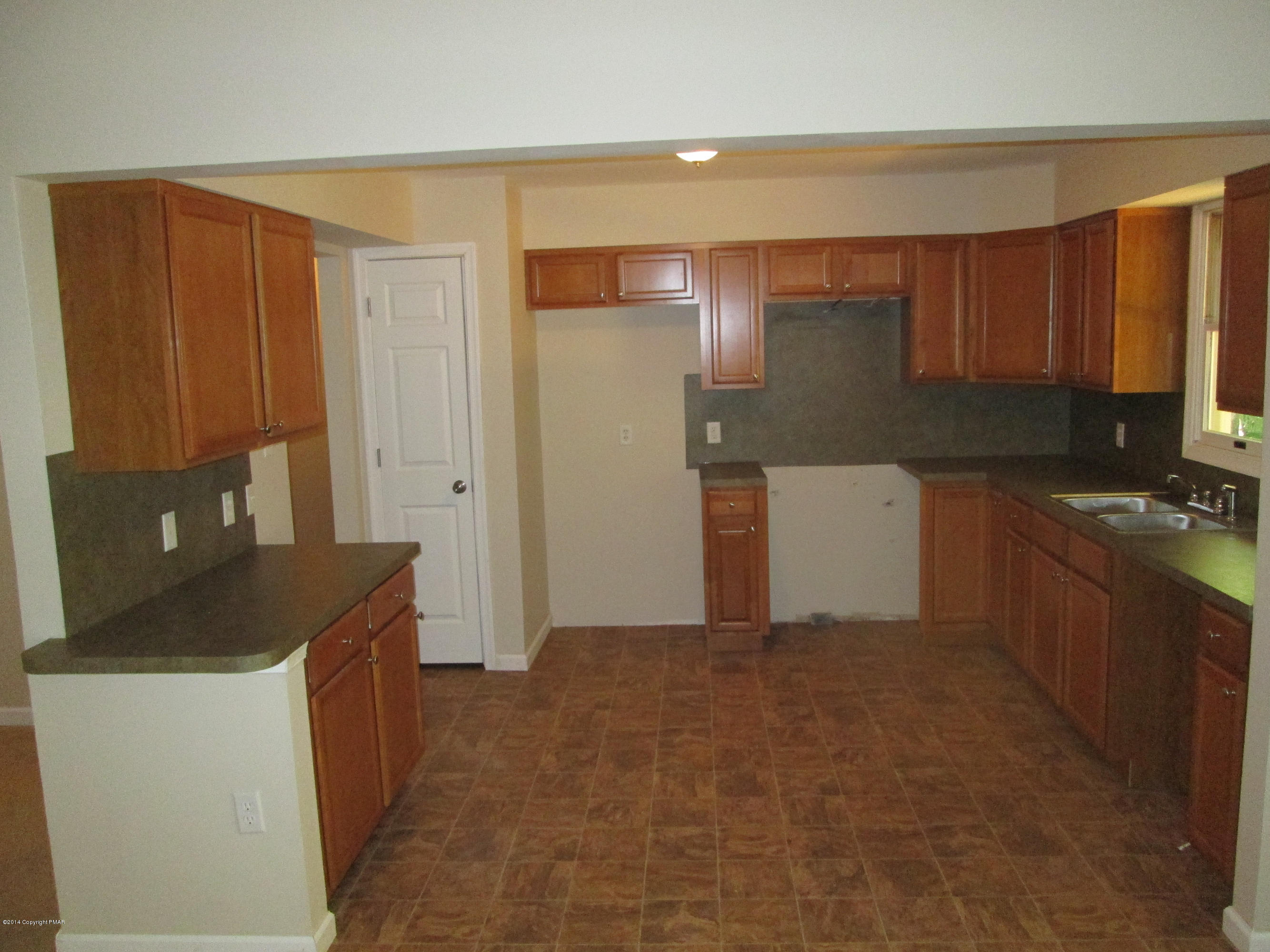 1504 Astolat Road Effort, PA 18330 - Photo 5 of 15 a kitchen with a refrigerator and a stove