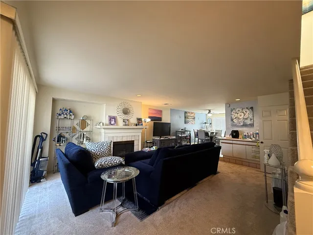 a living room with furniture and a kitchen