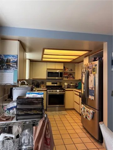 a kitchen with a stove a sink and a refrigerator