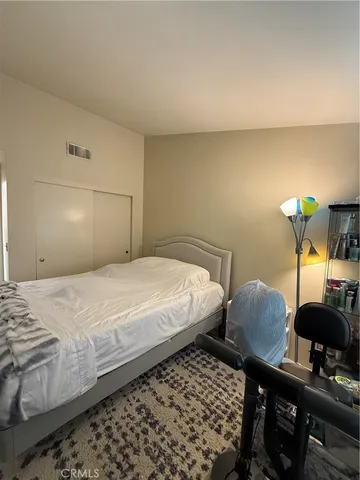 a bedroom with bed and a window