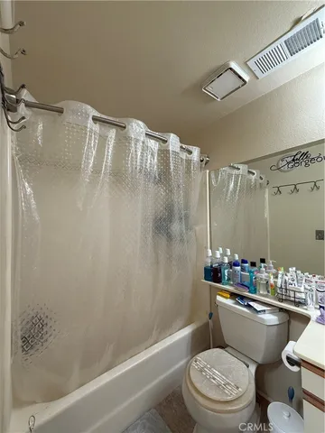 a bathroom with a toilet a sink and shower