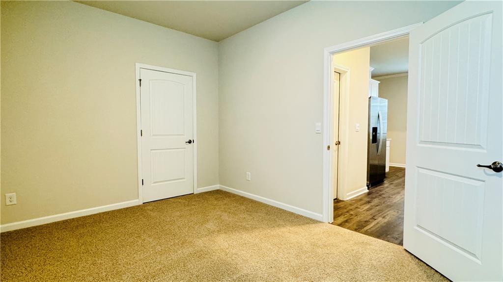 5114 Tulip Square Acworth, GA 30101 - Photo 12 of 36 an empty room with wooden floor and a window