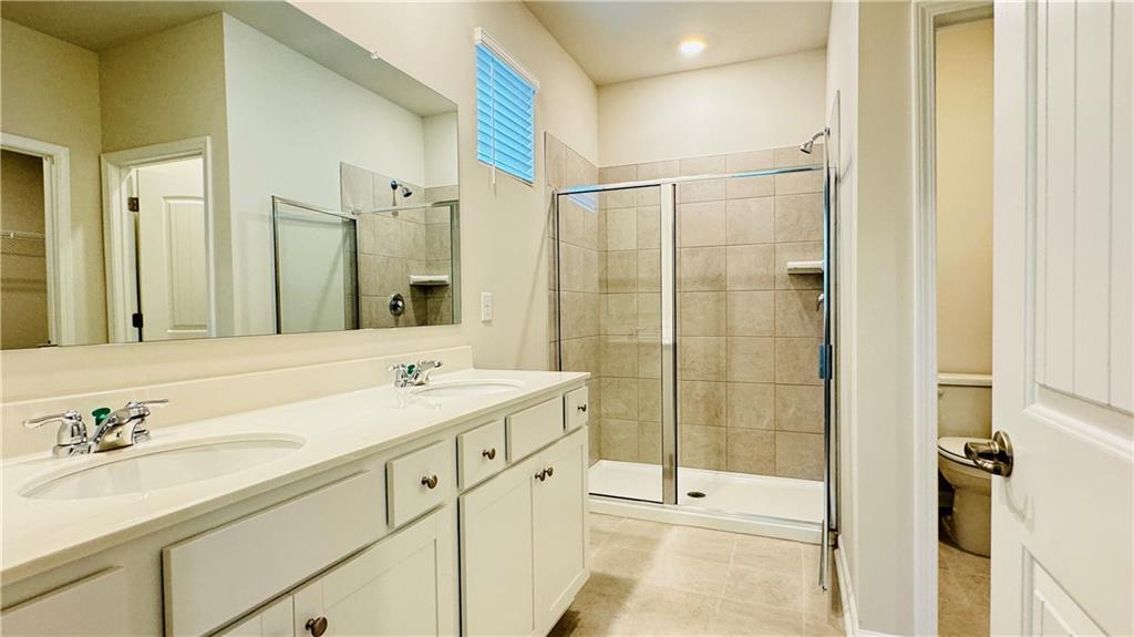 5114 Tulip Square Acworth, GA 30101 - Photo 18 of 36 a bathroom with a shower sink vanity and mirror