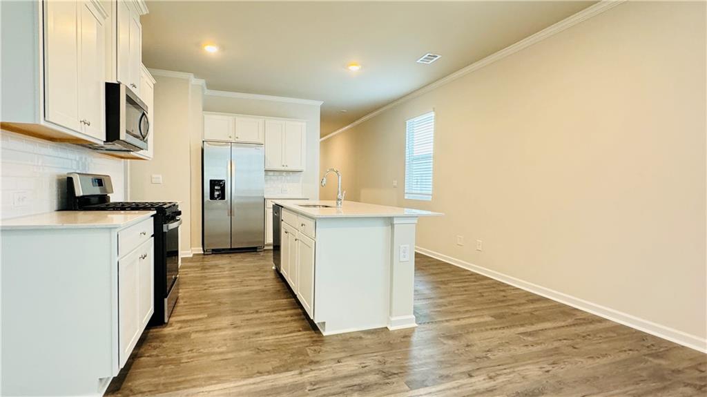 5114 Tulip Square Acworth, GA 30101 - Photo 5 of 36 a kitchen with stainless steel appliances granite countertop a stove a sink and a refrigerator