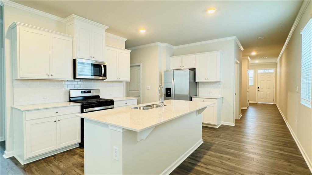 5114 Tulip Square Acworth, GA 30101 - Photo 6 of 36 a kitchen with stainless steel appliances a stove refrigerator sink and microwave
