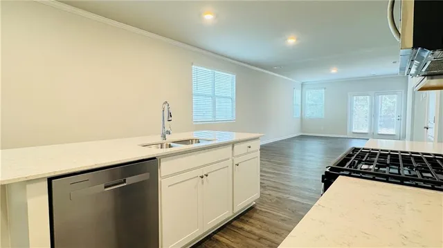 a kitchen with a sink and a stove top oven