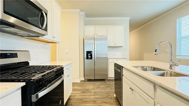 a kitchen that has a sink and a stove