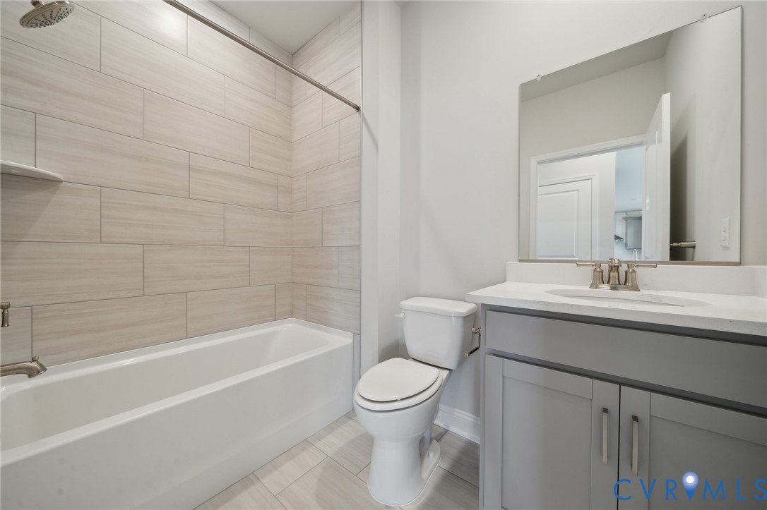 16801 Copperland Point Chesterfield, VA 23832 - Photo 15 of 17 a bathroom with a granite countertop toilet a sink and a bathtub