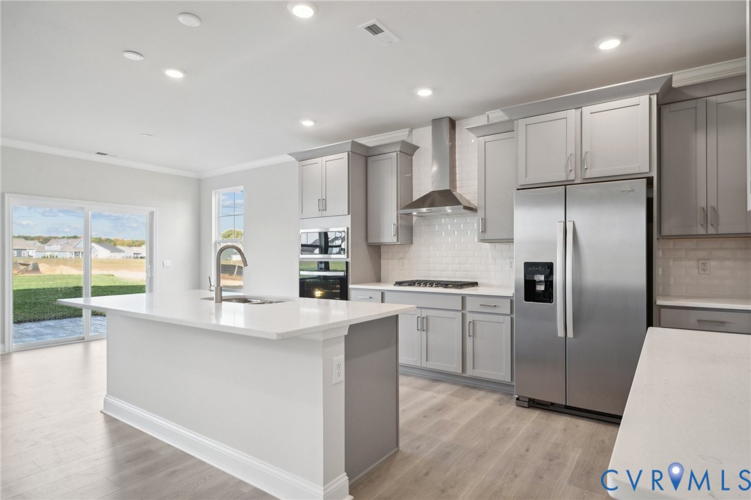 16801 Copperland Point Chesterfield, VA 23832 - Photo 4 of 17 a kitchen with stainless steel appliances granite countertop a refrigerator a sink a stove and white cabinets with wooden floor