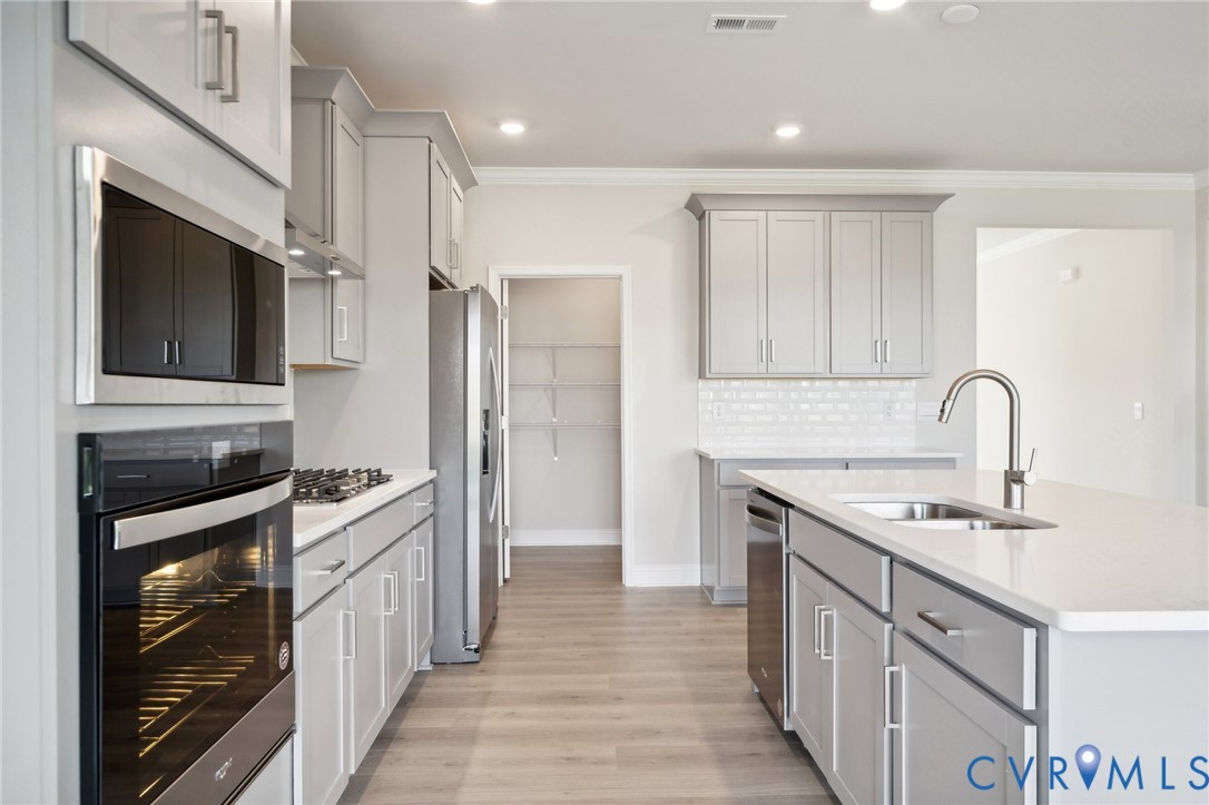 16801 Copperland Point Chesterfield, VA 23832 - Photo 6 of 17 a kitchen with stainless steel appliances granite countertop a sink stove and refrigerator