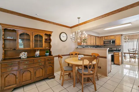 a dining area with furniture and kitchen view