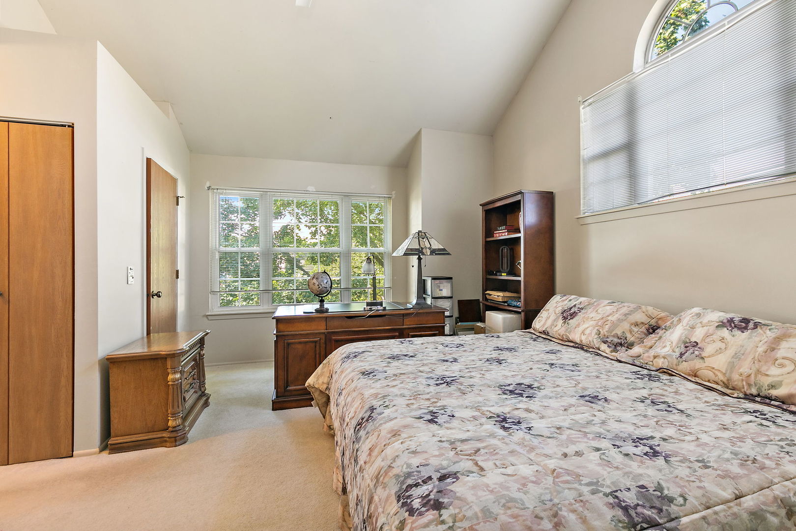 133 White Branch Court South, Unit 133 Schaumburg, IL 60107 - Photo 17 of 27 a bedroom with a large bed and a large window