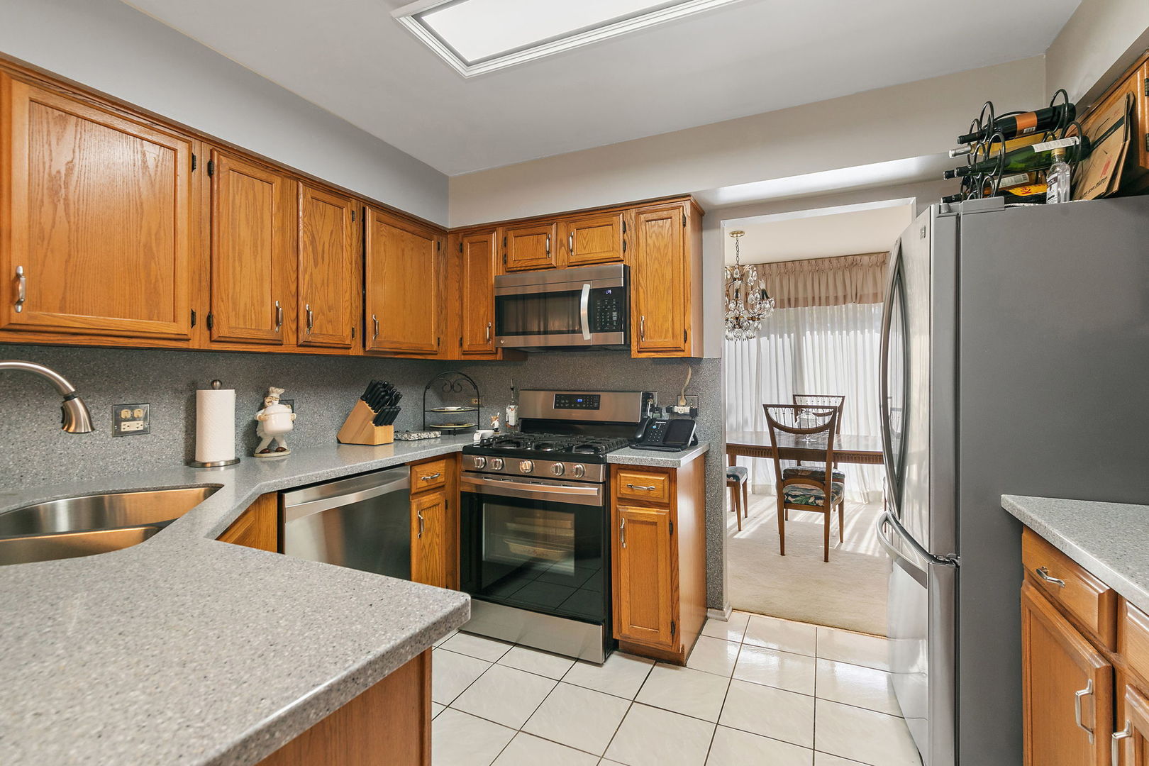 133 White Branch Court South, Unit 133 Schaumburg, IL 60107 - Photo 10 of 27 a kitchen with stainless steel appliances granite countertop a stove sink and cabinets