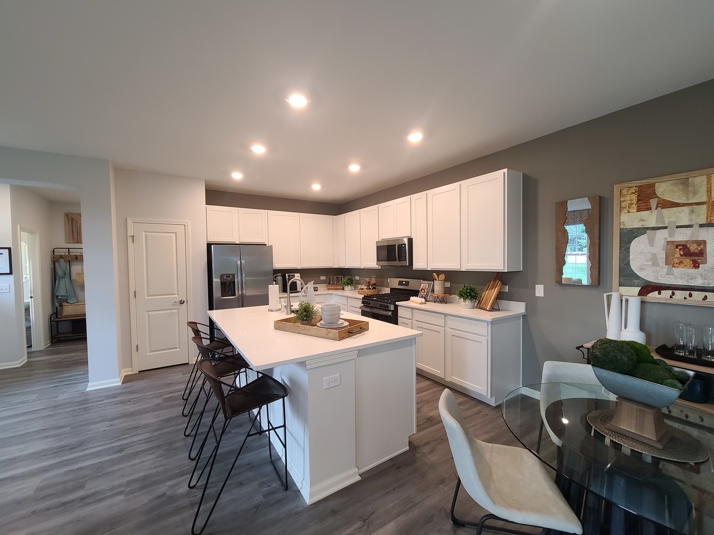 1214 Draper Road McHenry, IL 60050 - Photo 8 of 33 a kitchen with a dining table chairs and wooden floor