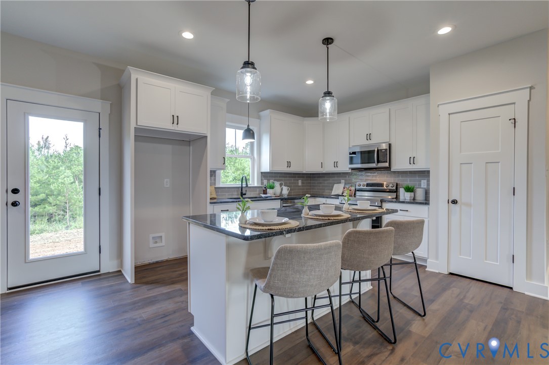5306 St Pauls Church Road Goochland, VA 23063 - Photo 16 of 35 a kitchen with kitchen island granite countertop a sink a center island and appliances