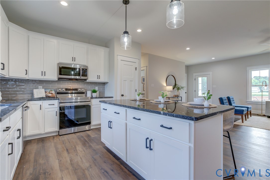5306 St Pauls Church Road Goochland, VA 23063 - Photo 21 of 35 a kitchen with granite countertop a sink cabinets and stainless steel appliances