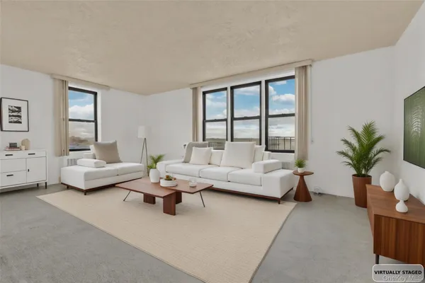 a living room with furniture and a large window with garden view