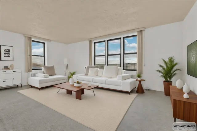 a living room with furniture and a large window with garden view