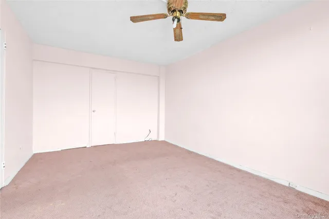 a view of a room with a ceiling fan
