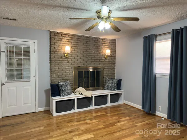 a view of a livingroom with furniture window and wooden floor
