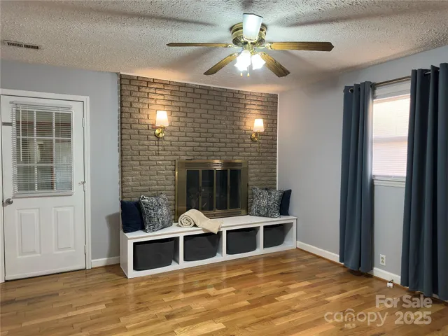 a view of a livingroom with furniture window and wooden floor
