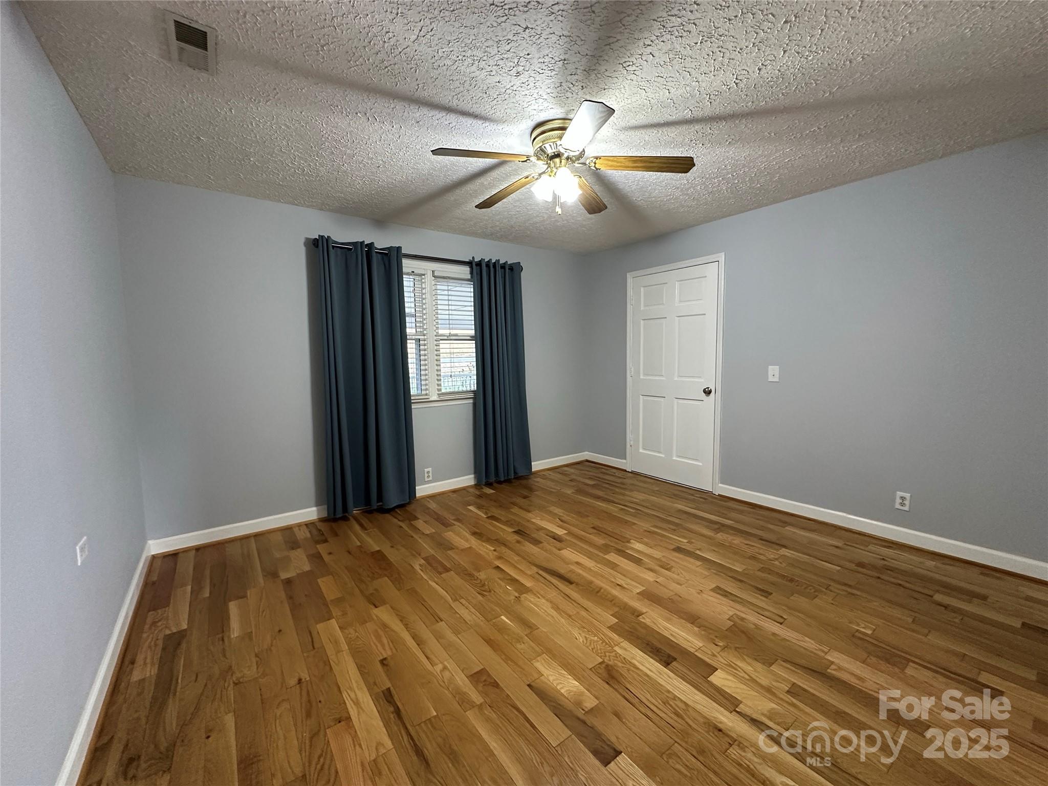 2945 Freezer Locker Road Hudson, NC 28638 - Photo 16 of 38 a view of a big room with wooden floor and windows in a room