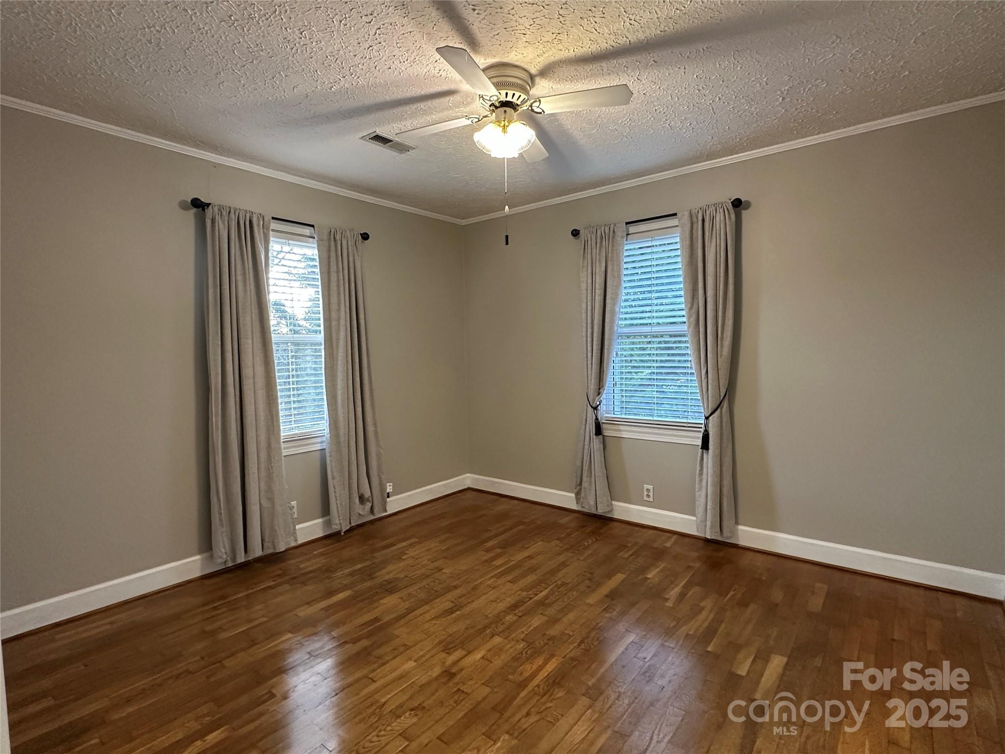 2945 Freezer Locker Road Hudson, NC 28638 - Photo 23 of 38 an empty room with wooden floor fan and windows