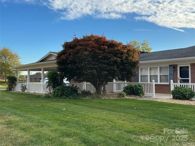 a view of a house with a yard and tree s