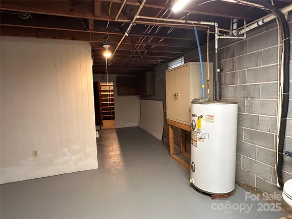 a view of storage and utility room with stairs and washer