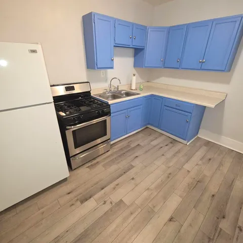 a kitchen with wooden cabinets and white appliances