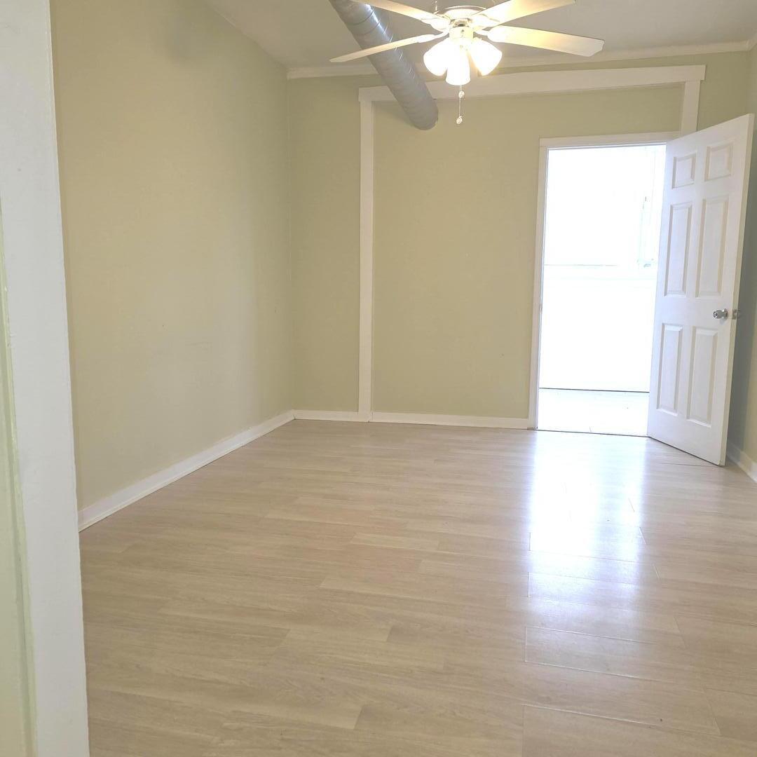 3301 West Potomac Avenue, Unit G Chicago, IL 60651 - Photo 6 of 18 a view of an empty room with wooden floor