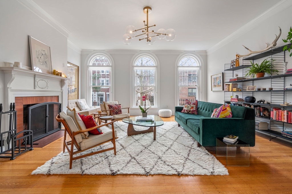49 Garrison Road Brookline, MA 02445 - Photo 11 of 25 a living room with furniture a fireplace and a chandelier