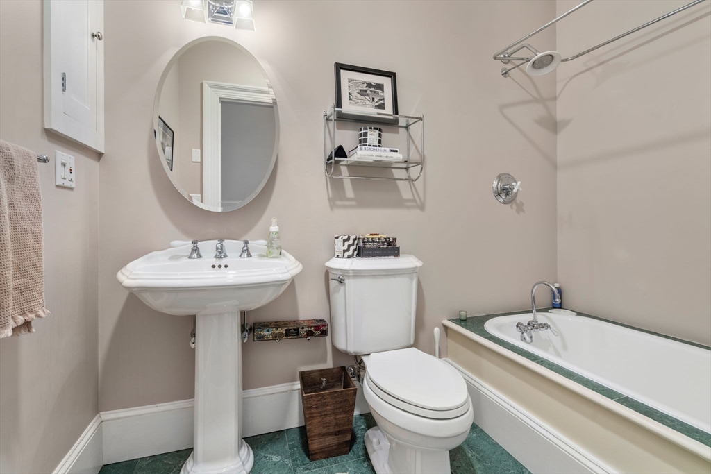 49 Garrison Road Brookline, MA 02445 - Photo 14 of 25 a bathroom with a sink toilet and a mirror
