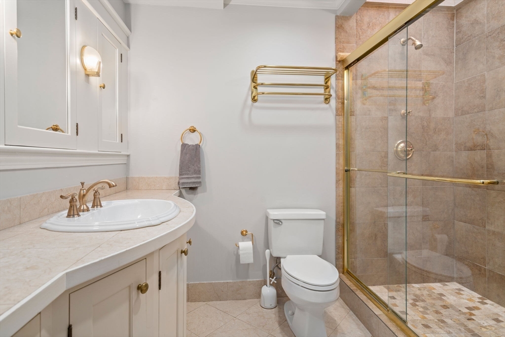 49 Garrison Road Brookline, MA 02445 - Photo 17 of 25 a bathroom with a sink toilet and shower