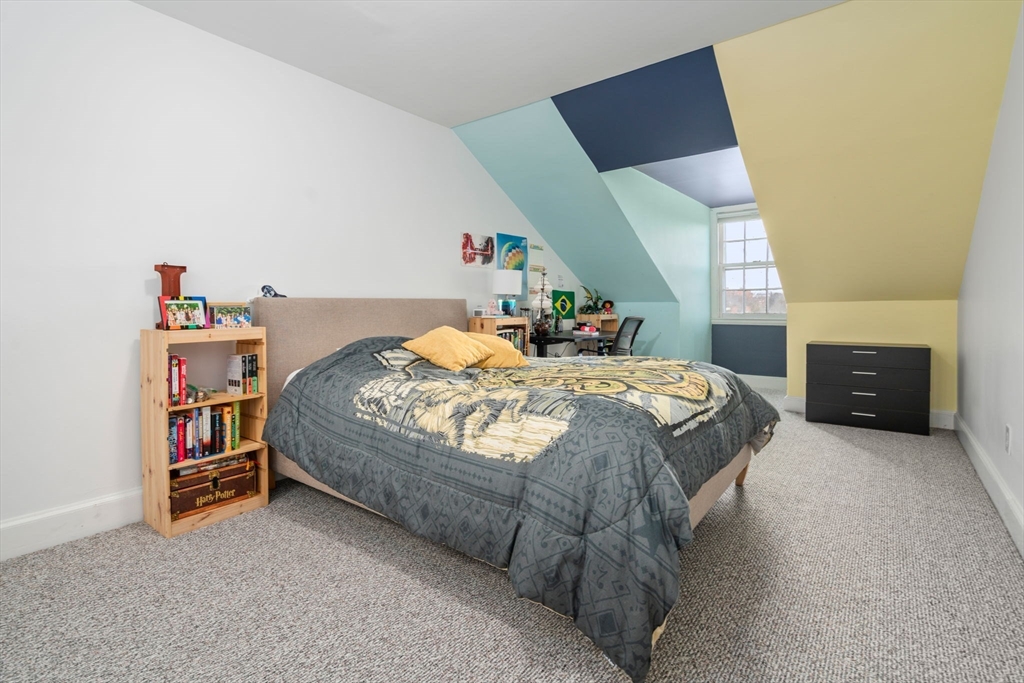 49 Garrison Road Brookline, MA 02445 - Photo 22 of 25 a bed sitting in a bedroom next to a lamp