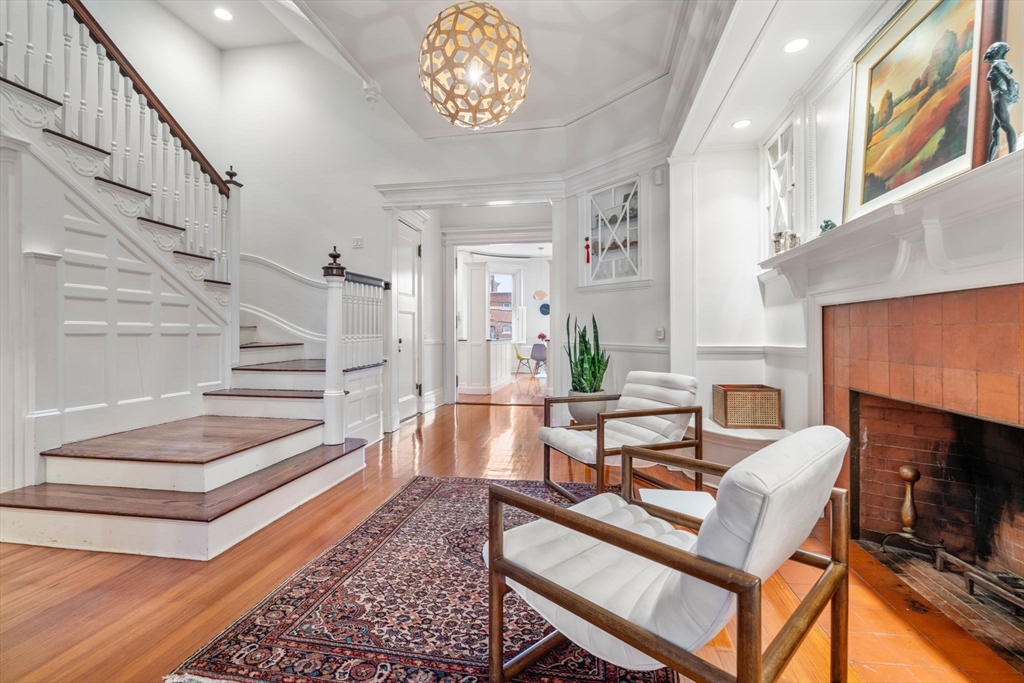 49 Garrison Road Brookline, MA 02445 - Photo 4 of 25 a living room with furniture and a fireplace