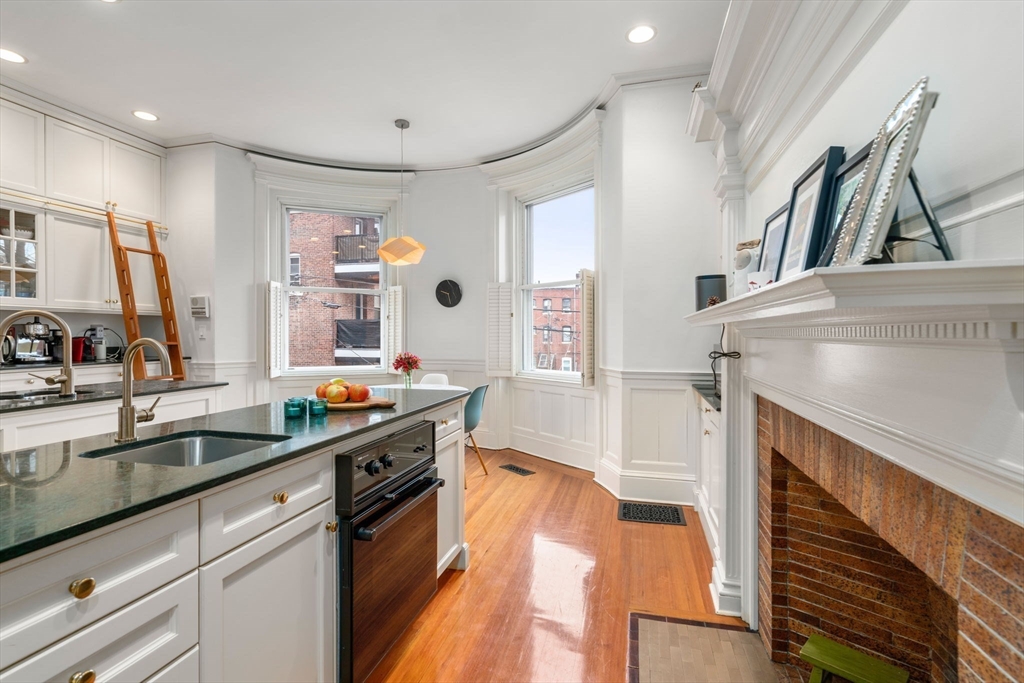 49 Garrison Road Brookline, MA 02445 - Photo 5 of 25 a kitchen with stainless steel appliances a sink and a stove