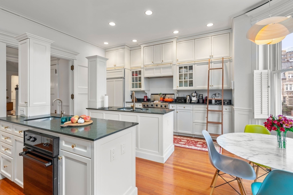49 Garrison Road Brookline, MA 02445 - Photo 6 of 25 a kitchen with kitchen island granite countertop a white cabinets and refrigerator