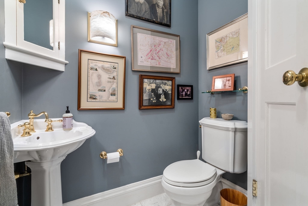 49 Garrison Road Brookline, MA 02445 - Photo 9 of 25 a bathroom with a toilet sink and mirror