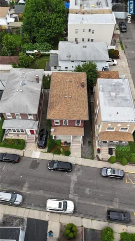 an aerial view of a house with garden space and street view