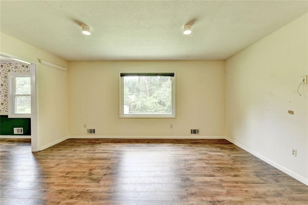 1577 Harbour Oaks Road Tucker, GA 30084 - Photo 6 of 58 an empty room with wooden floor and windows