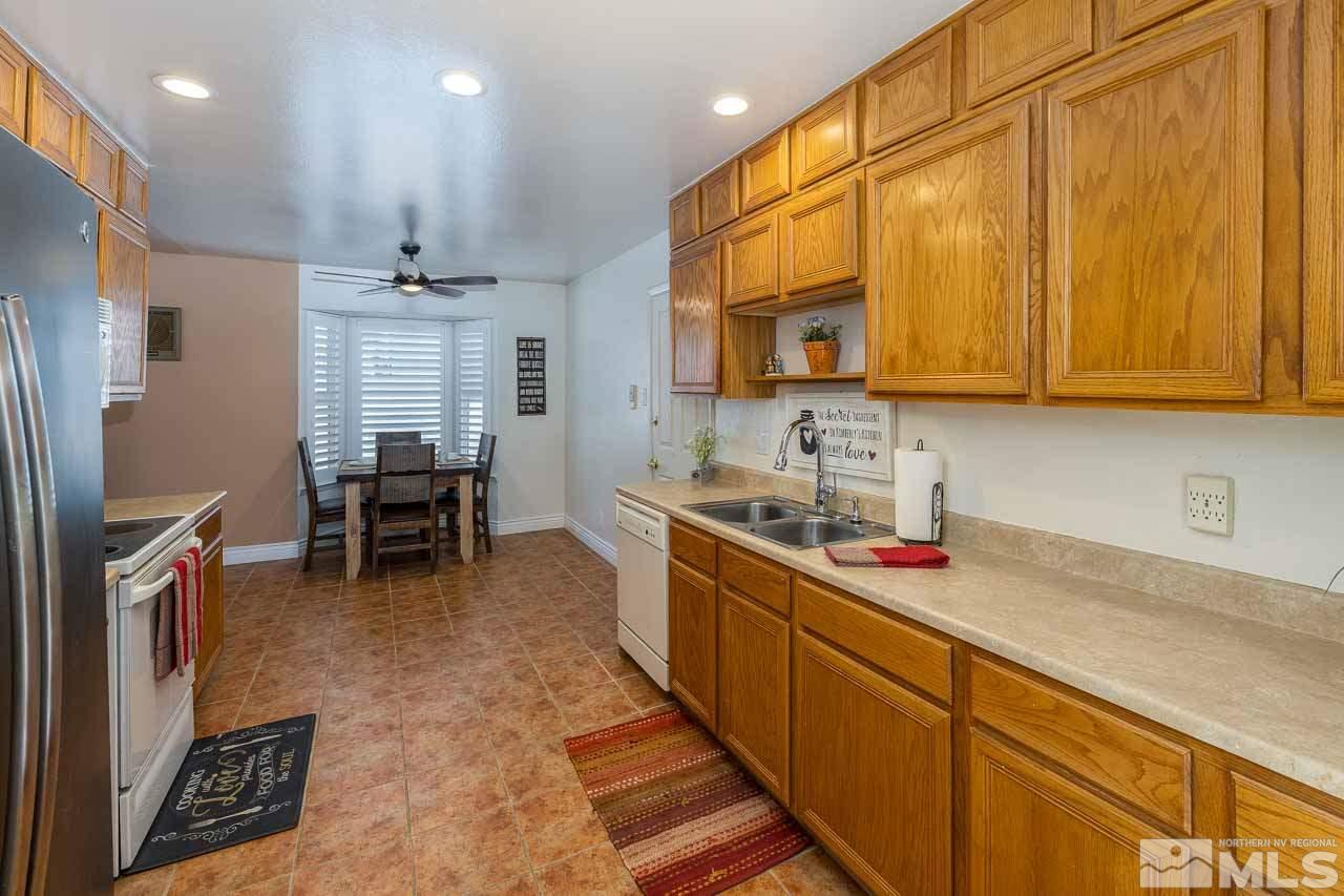 3665 Everett Drive Reno, NV 89503 - Photo 3 of 23 a kitchen with stainless steel appliances granite countertop sink cabinets and wooden floor