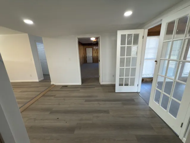 a kitchen with stainless steel appliances granite countertop a sink a stove and a wooden floors